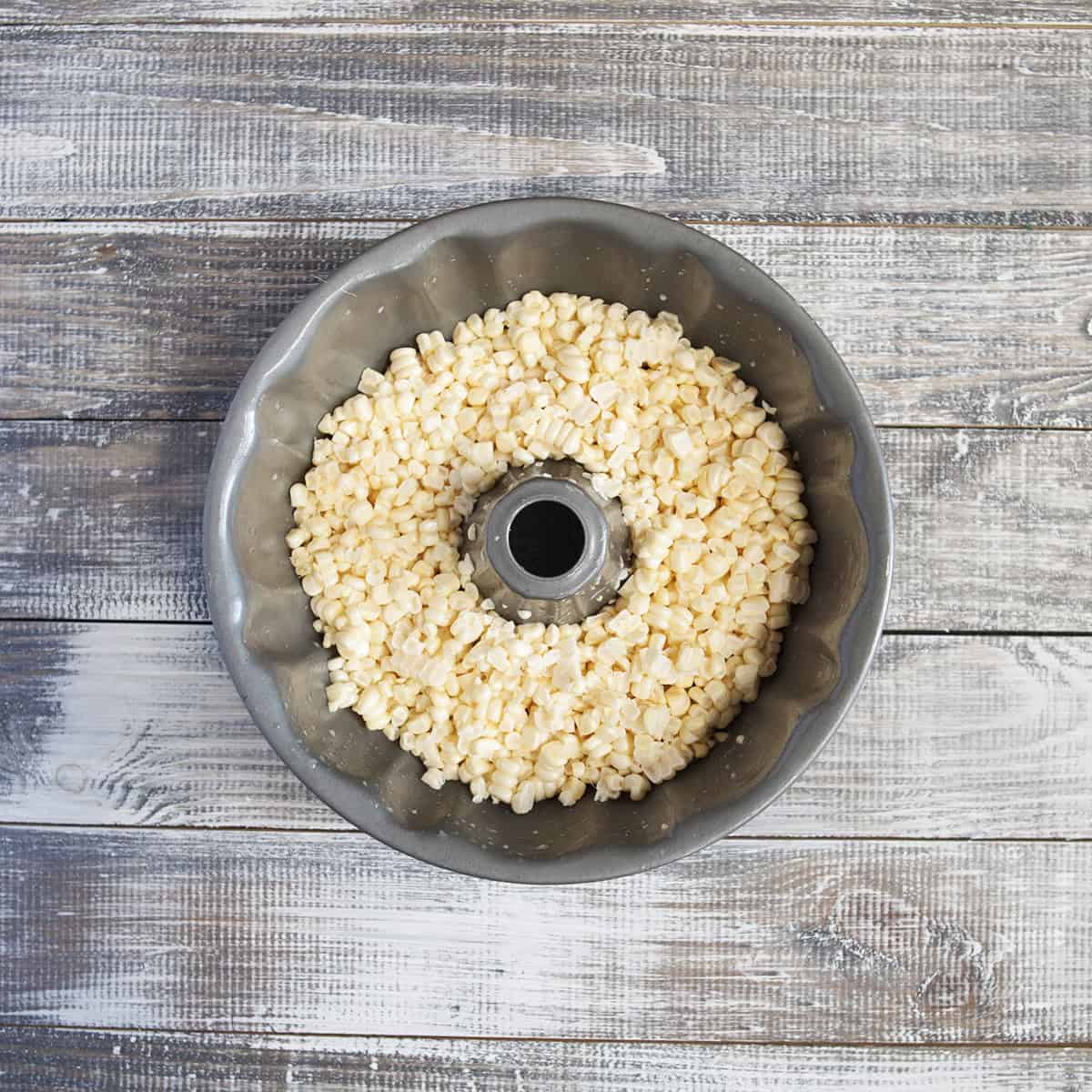 Fresh corn kernels in a bundt cake pan.